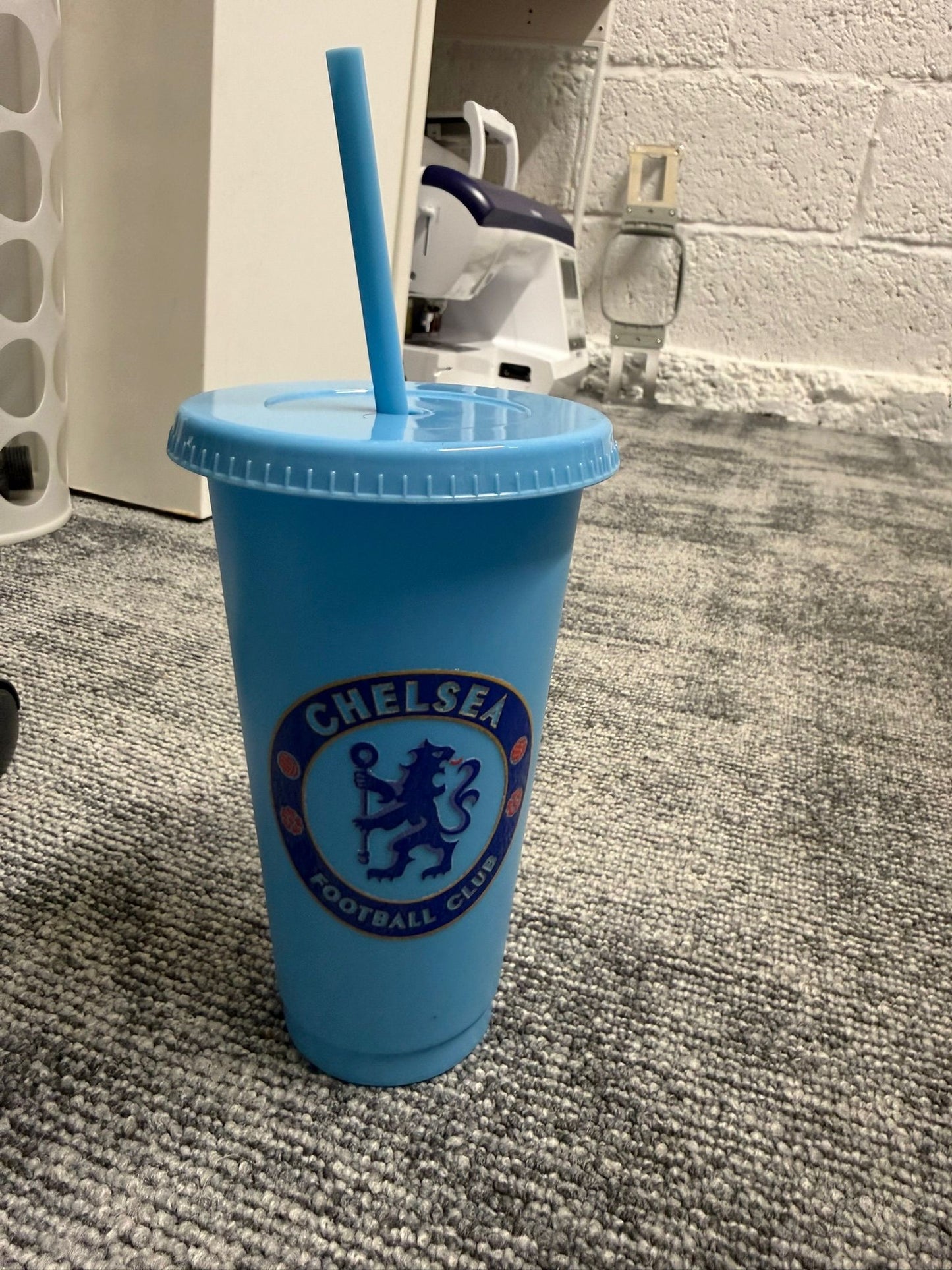 Football drinking cup with straw